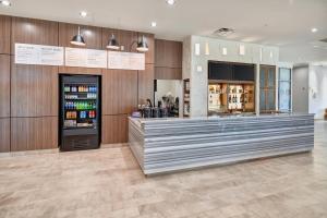 a restaurant with a counter and a refrigerator at Courtyard By Marriott El Paso Downtown/Convention Center in El Paso