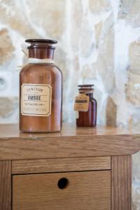 two jars sitting on top of a wooden table at Hotel De Belgique à Menton in Menton