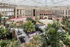 an indoor shopping mall with palm trees and buildings at Gaylord Palms Resort & Convention Center in Orlando