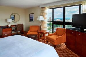 a hotel room with a bed and a flat screen tv at Ottawa Marriott Hotel in Ottawa