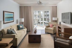 a living room with a couch and chairs and a table at Waterline Villas & Marina, Autograph Collection in Holmes Beach