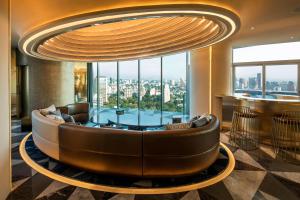 a lobby with a large couch in front of a large window at W Mexico City in Mexico City