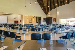 a large room filled with tables and chairs at Zebula Golf Estate and Spa - Zebula Golfers Lodge in Mabula