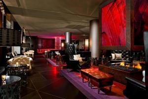 a lobby with tables and chairs and red lighting at W Minneapolis - The Foshay in Minneapolis