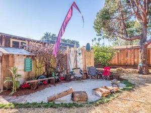 a backyard with a fire pit and chairs and surfboards at Relaxing 3 bedroom Santa Cruz house, 5min to beach in Santa Cruz