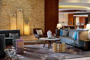 a living room with a couch and a table at Renaissance Palm Springs Hotel in Palm Springs