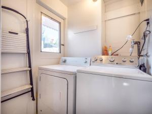 a small laundry room with a washer and dryer at Relaxing 3 bedroom Santa Cruz house, 5min to beach in Santa Cruz +48 photos