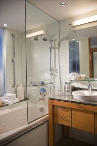 a bathroom with a shower and a sink at La Concha Renaissance San Juan Resort in San Juan