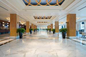 a lobby with columns and plants in a building at Gaylord National Resort & Convention Center in National Harbor