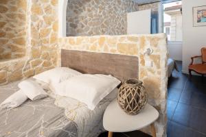 a bedroom with a bed and a table and a chair at Hotel De Belgique à Menton in Menton