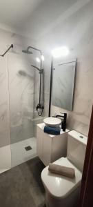 a bathroom with a toilet and a sink and a shower at Riells mar in L'Escala