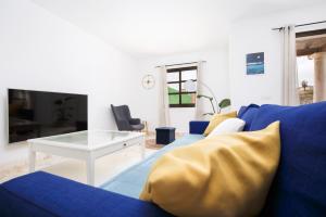 Televízia a/alebo spoločenská miestnosť v ubytovaní FTV Holidays Homes