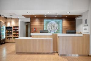 a lobby of a store with a reception desk and a counter at Fairfield Inn & Suites Rancho Cordova in Rancho Cordova
