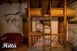 a bunk bed with a ladder in a room at Alphütte "Hittä" in Simplon-Dorf im sonnigen Wallis in Simplon Dorf