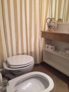 a bathroom with a white toilet and a sink at escapada porteña in Buenos Aires