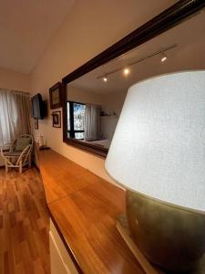 a living room with a lamp and a mirror at escapada porteña in Buenos Aires