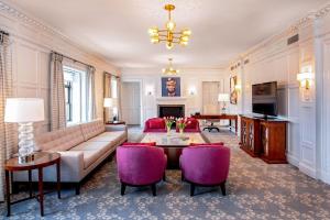 a living room with a couch and a table and chairs at Peoria Marriott Pere Marquette in Peoria