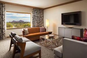 a living room with a couch and a television at The Canyon Suites at The Phoenician, a Luxury Collection Resort, Scottsdale in Scottsdale