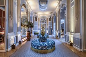 a large room with a blue bench in the middle of it at Santo Mauro, a Luxury Collection Hotel, Madrid in Madrid