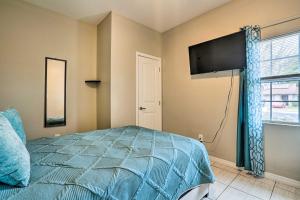 a bedroom with a bed and a flat screen tv at Pet-Friendly San Antonio Vacation Rental! in San Antonio