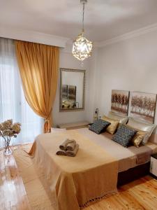 a bedroom with a large bed with shoes on it at Antigonidon Square Luxury Apartment in Thessaloniki