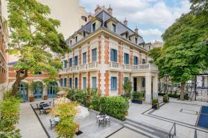 an image of a building with tables and chairs at Santo Mauro, a Luxury Collection Hotel, Madrid in Madrid