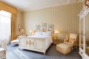 a bedroom with a large white bed and a chair at Hotel Bristol, A Luxury Collection Hotel, Warsaw in Warsaw