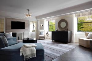 a living room with a blue couch and a tv at JW Marriott Essex House New York in New York