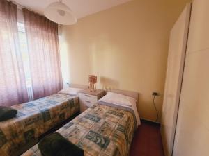 a bedroom with two beds and a window at P in centro in Sestri Levante
