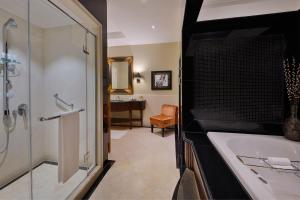 a bathroom with a shower and a tub and a sink at The Westin Dubai Mina Seyahi Beach Resort and Waterpark in Dubai