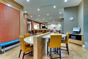 a dining room with a table and chairs at TownePlace Suites by Marriott Houston Northwest Beltway 8 in Houston