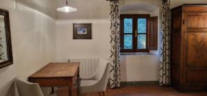 uma sala de jantar com uma mesa e cadeiras e uma janela em Il Poggio B&B em Ginestra