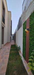 a hallway of a building with a green wall at فيلا ضاحية الرمال in Riyadh
