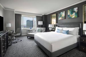 a hotel room with a large bed and a desk at The Ritz-Carlton, Tysons Corner in Tysons Corner