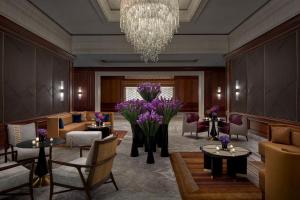 a lobby with couches and tables and a chandelier at The Ritz-Carlton, Tysons Corner in Tysons Corner