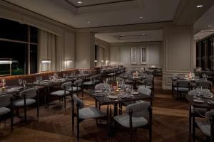 a restaurant with tables and chairs in a room at The Ritz-Carlton, Tysons Corner in Tysons Corner