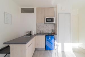 eine Küche mit einem blauen Kühlschrank und einer Theke in der Unterkunft ZenBNB / Sweet Apartment / Studio / Proche Genève in Annemasse