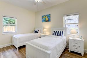 a bedroom with two white beds and two windows at Dog-Friendly Home with Pool and Yard in Bradenton in Bradenton +24 photos