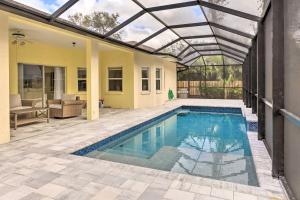 an indoor swimming pool with a pergola over a house at Dog-Friendly Home with Pool and Yard in Bradenton in Bradenton
