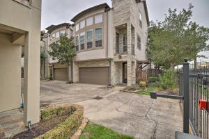 a large house with a gate and a driveway at East Dtwn Houston Vacation Rental Near Stadiums in Houston