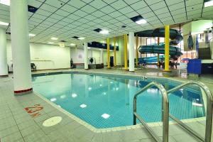 a large swimming pool with a slide in a building at Delta Hotels by Marriott Regina in Regina