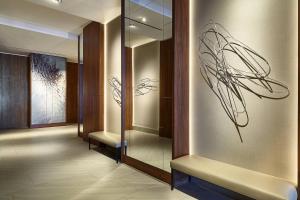 a hallway with glass doors and a wall with art on it at AC Hotel by Marriott Lima Miraflores in Lima