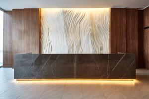 a reception desk in a lobby with wooden walls at AC Hotel by Marriott Lima Miraflores in Lima