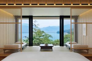 a bedroom with a view of the ocean at The Ritz-Carlton, Nikko in Nikko