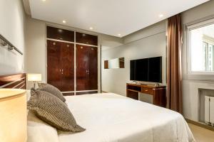 a bedroom with a large bed and a television at Up Retiro in Buenos Aires