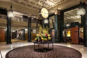 a lobby with a clock and flowers on a table at The Westin St. Francis San Francisco on Union Square in San Francisco