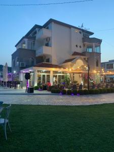 a large building with a lawn in front of it at Stella Guesthouse in Ulcinj