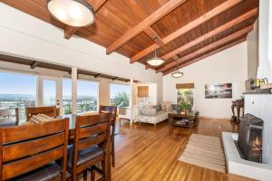 a living room with a fireplace and wooden ceilings at OCEAN VIEW - entire home - Excellent location in San Diego