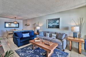 a living room with a couch and a table at Direct Ocean Front 3BR/2BA Dog Friendly in Myrtle Beach