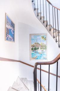 a staircase in a house with a painting on the wall at Hotel De Belgique à Menton in Menton